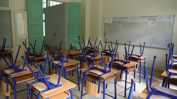Chairs are placed on classroom tables at a closed public school in Beirut.